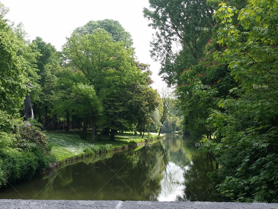 Beautiful park, green trees and little river.
Bruges - Belgium