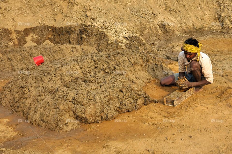 Man making bricks from mud