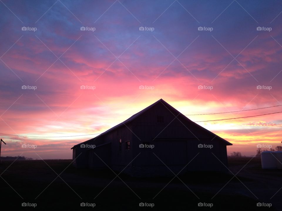 Spectacular sunset behind century old shed.  Reminiscent of Little House on the Prairie.