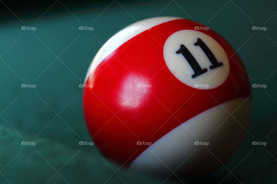 Close-up of a pool ball on top of a pool table.