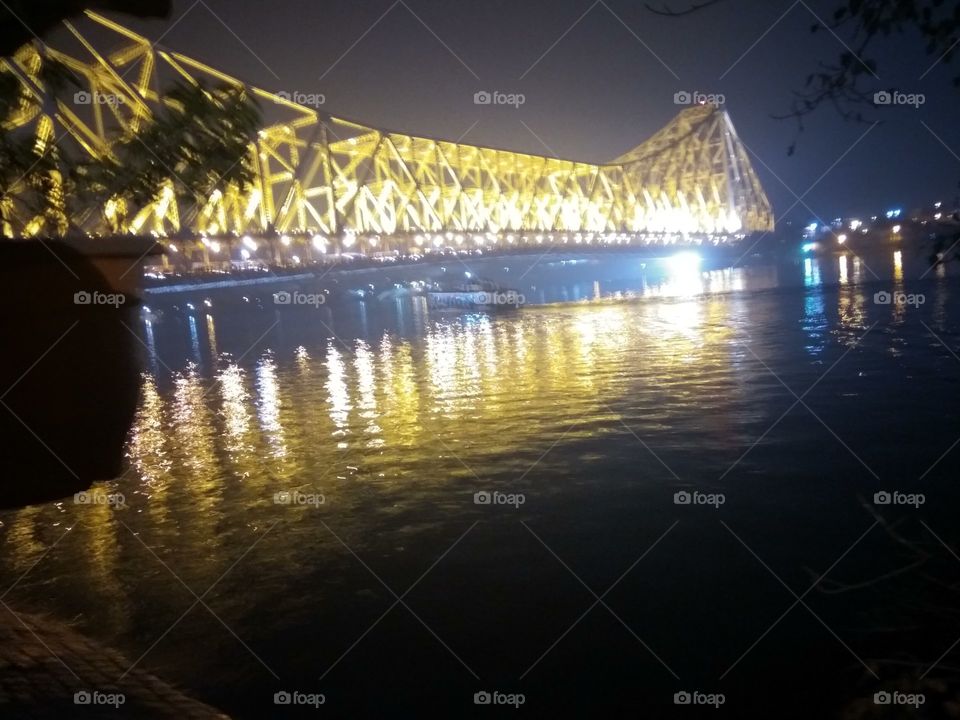 Night Scene of Illuminated Howrah bridge Over Hugli River, Kolkata City India. Constructed in 1942 AD,
Quality-Pillar less
Made from Steel