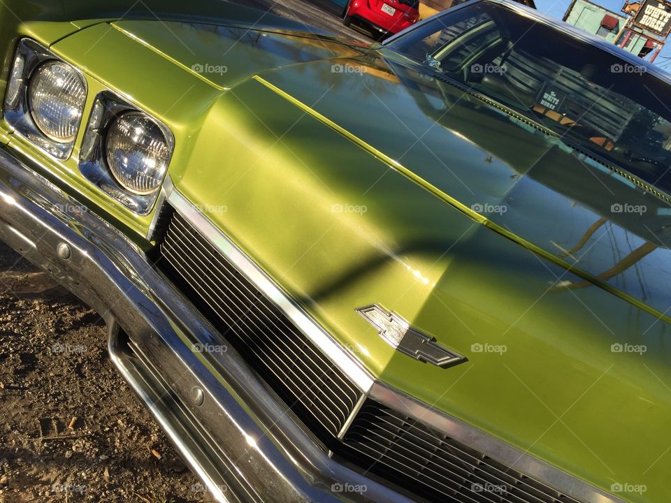 Focus adjustment on classic green Chevy in sunlight.