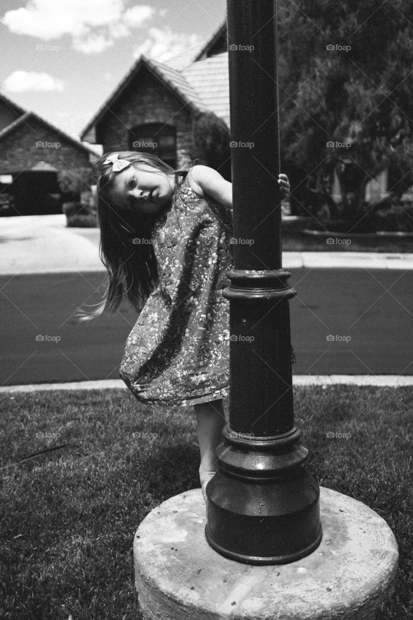 girl swinging around pole