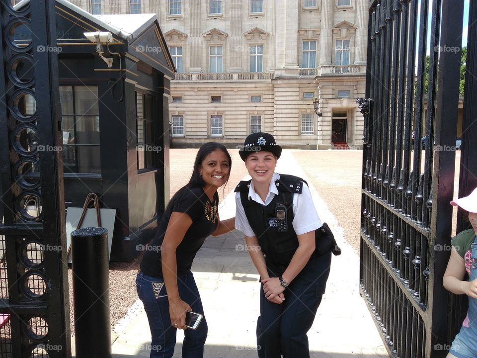 Woman with female police officer standing near gate