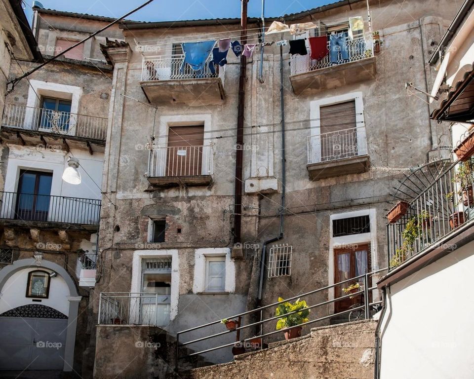 A Building with a bunch of clothes hanging out to dry