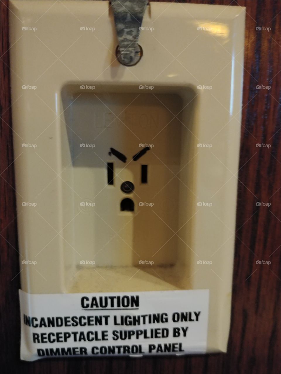 A creative electrical socket that looks like it is angry.