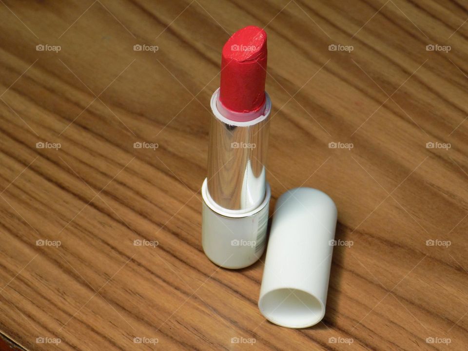 Lipstick on the brown wood table