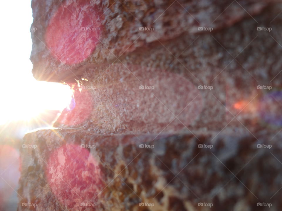 Illuminating sunrays behind the wall