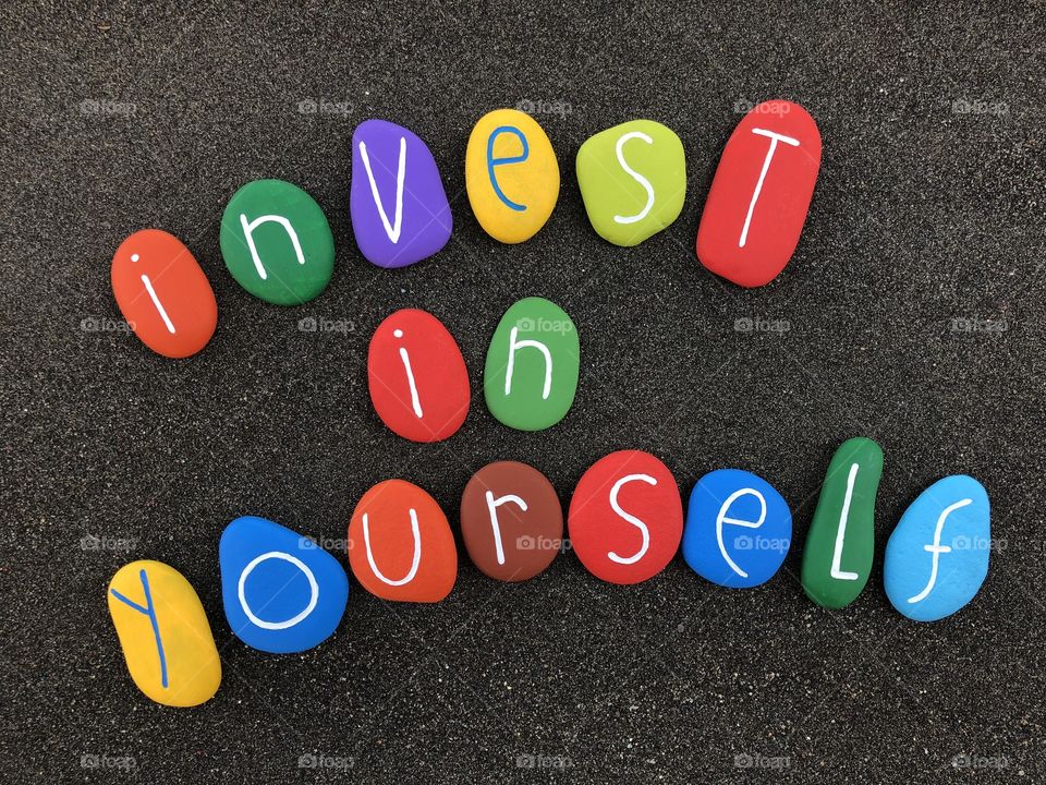 Invest in yourself. Business motivation and personal branding concept with colored stones