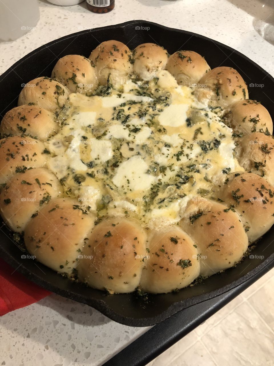 Freshly baked rolls with spinach artichoke dip 