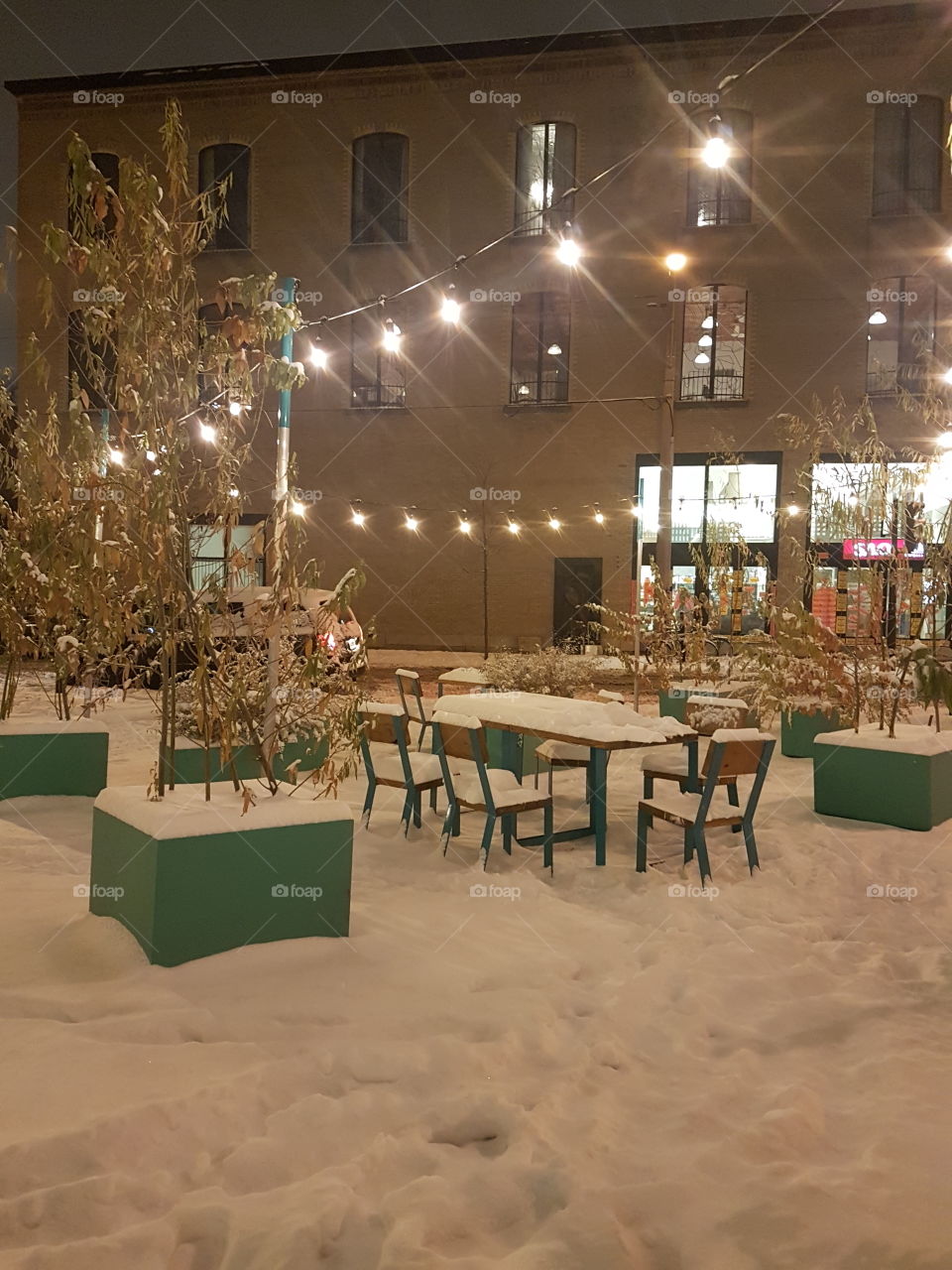 First snow on a public square with lights. Montréal. Québec. Canada.