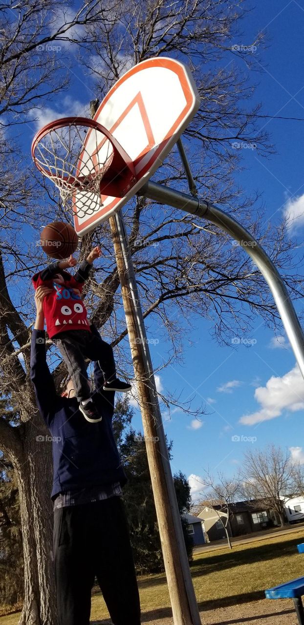 Littlest brother getting a boost from Biggest brother.