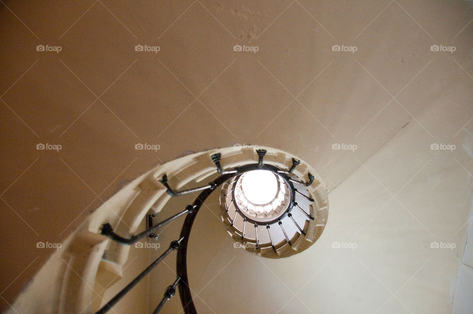 Looking up the center of a spiral staircase