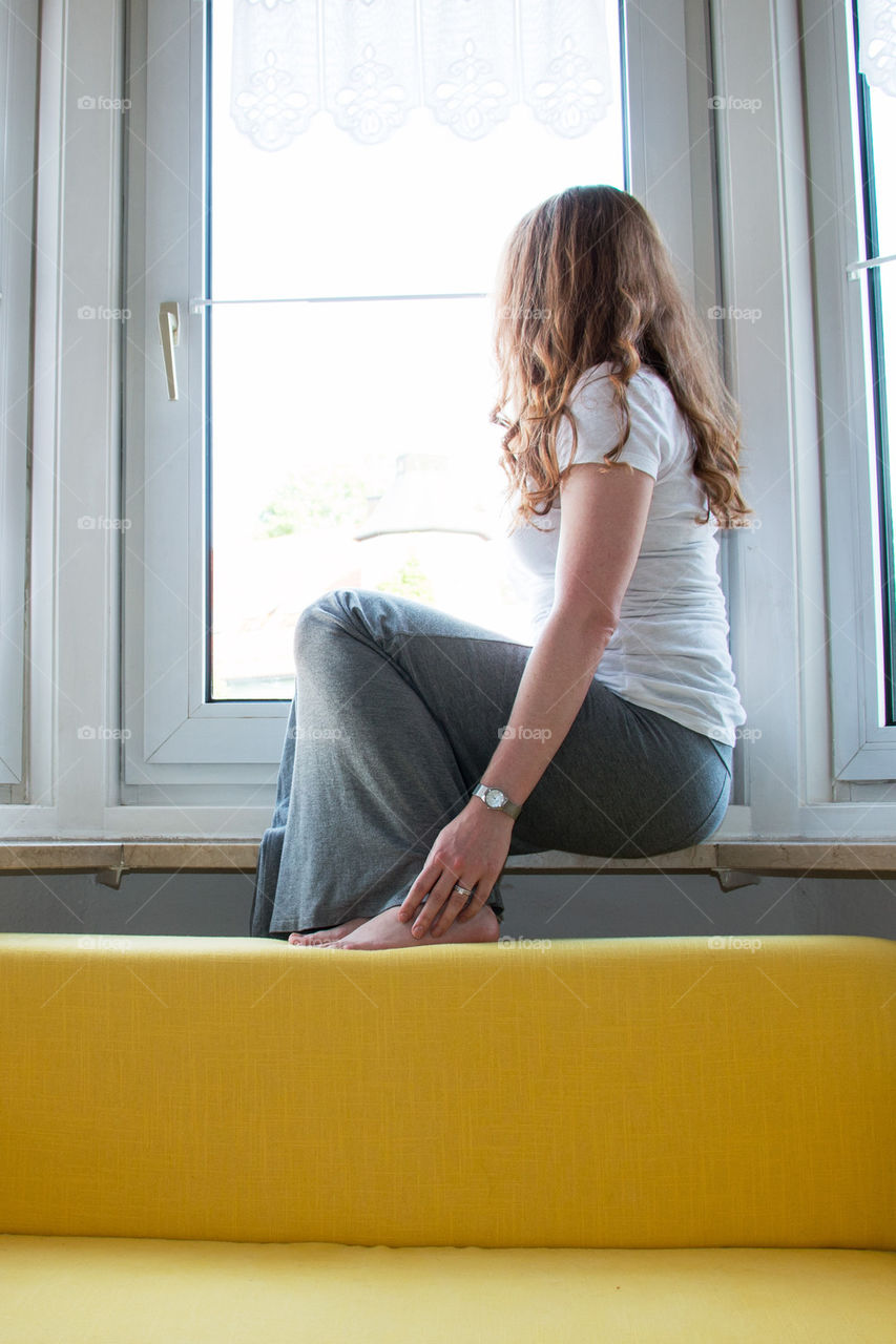 Young woman looking out the window 