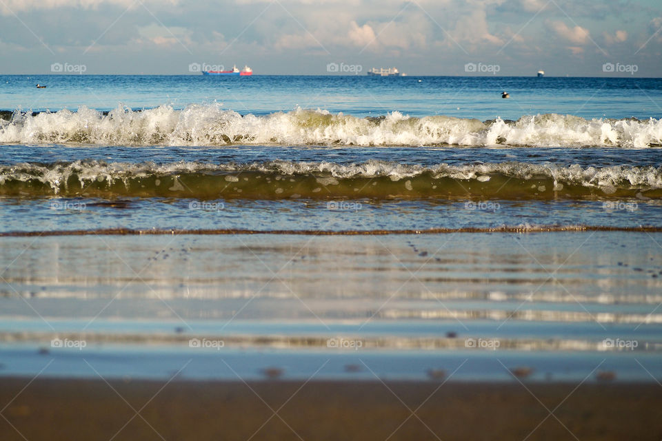 waves and ships in distance