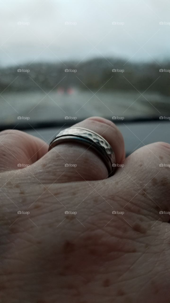 close up wedding band on finger