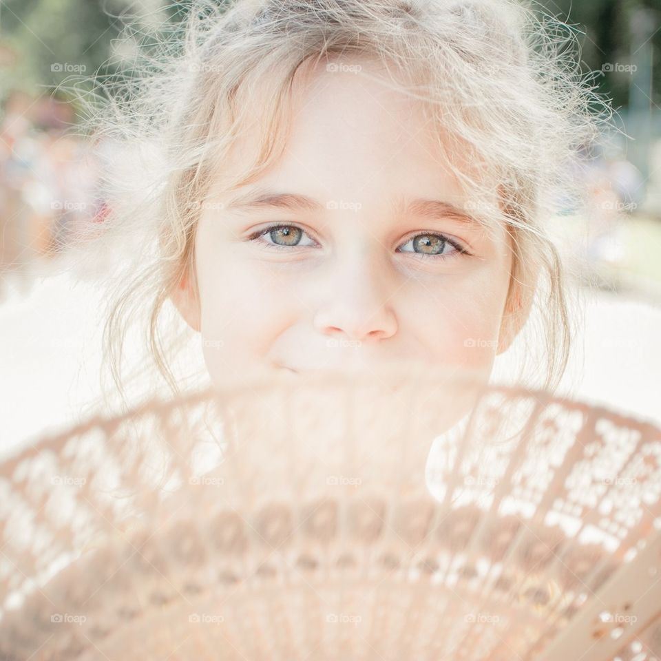 Little girl with fan