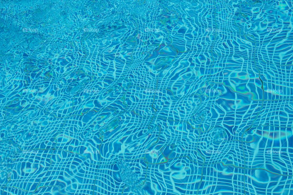 The texture of the wavy surface of the pool.  Turquoise color