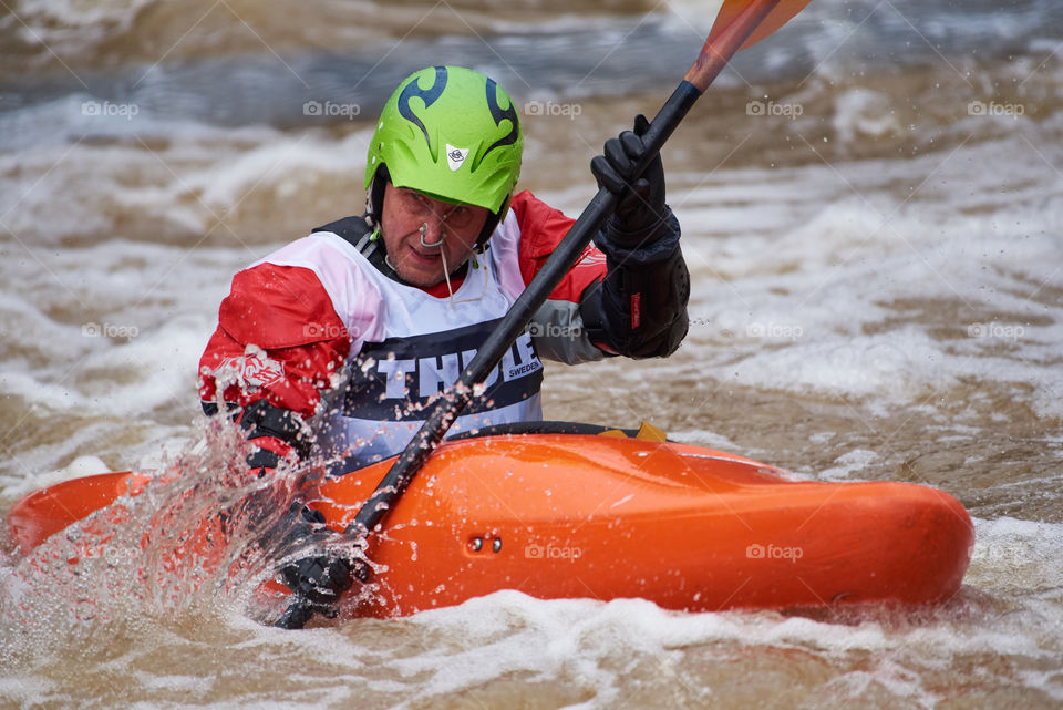 Helsinki, Finland - April 15, 2018: Unidentified racer at the annual Icebreak 2018 whitewater kayaking competition at the Vanhankaupunginkoski rapids in Helsinki, Finland.
