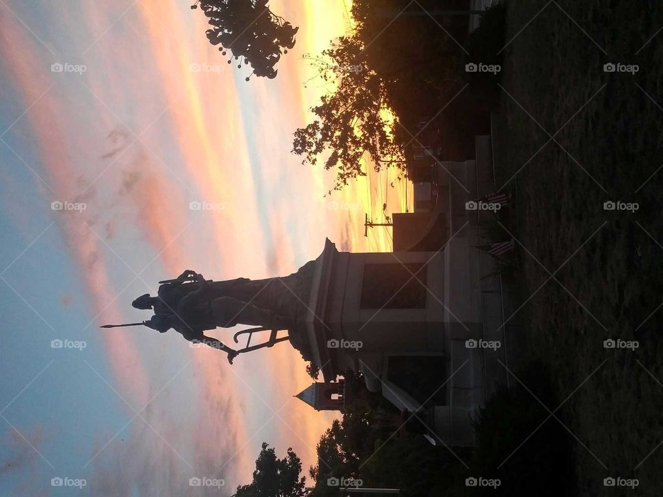 Sunset by the statue