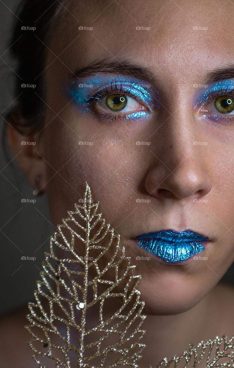 Portrait of a young woman wearing a make up 