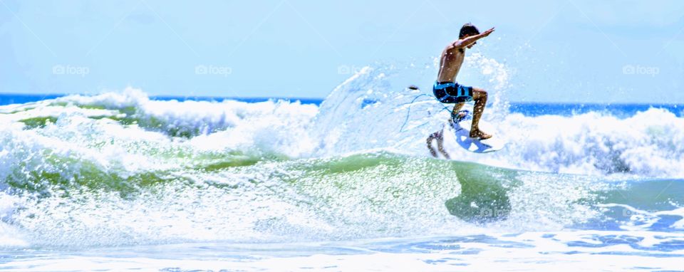 Surfer Riding Waves Catching Air