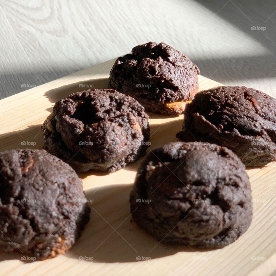 Double trouble chocolate cookies in the morning sun sitting at the kitchen freshly baked 