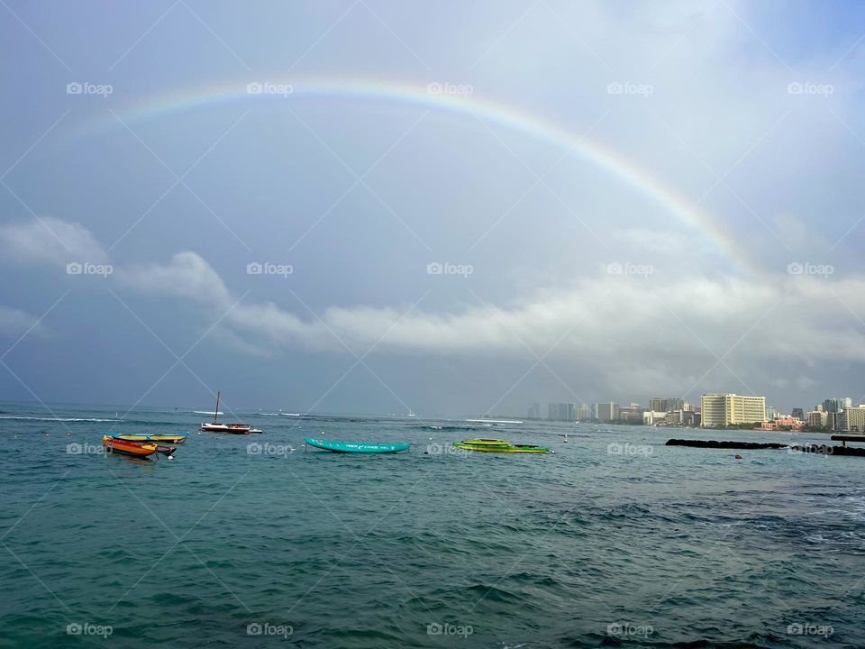 View of a beautiful rainbow over the Pacific Ocean from Kaluahole Beach in Honolulu Hawail
