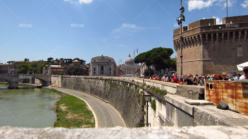St Peter's Basilica Rome Italy. viewed from the river Tiber with tourists gathered before Castel Sant'Angelo., (the Mausoleum of Hadrian).
