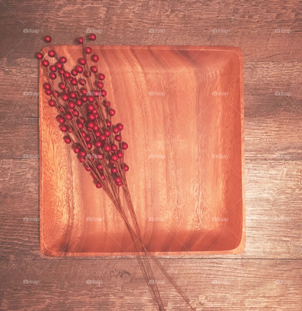 Red berries on wooden tray