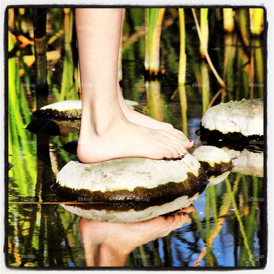 Feet exploring marsh