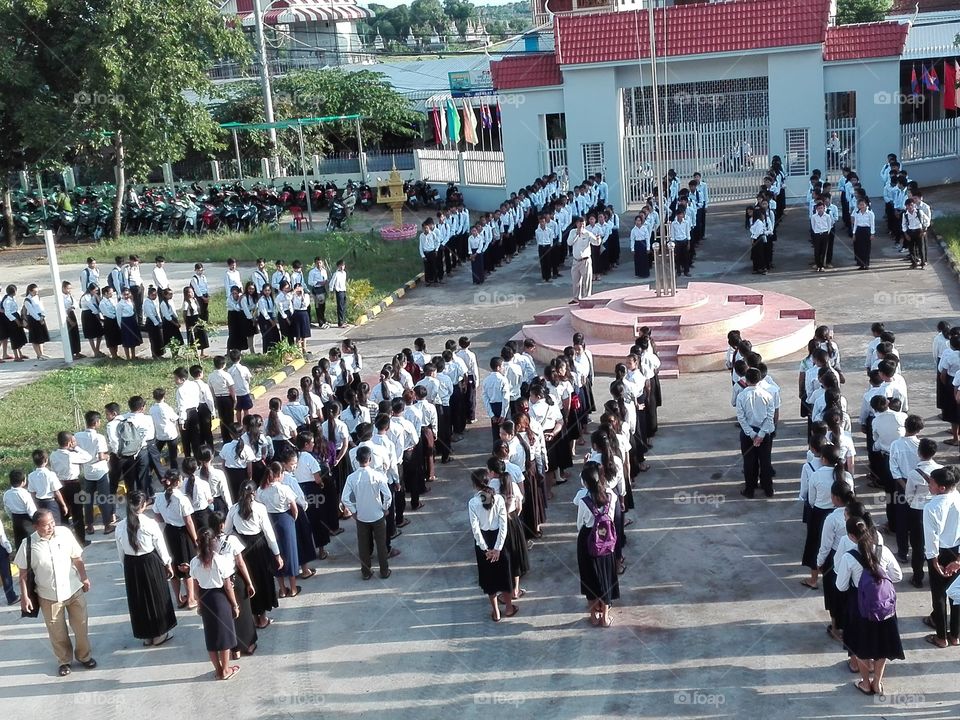 Khmer students stand in front of flag