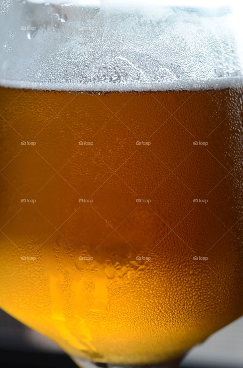 A closeup of a cold glass of beer.