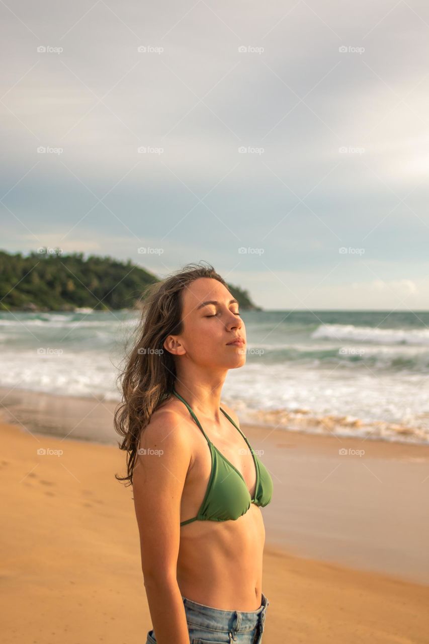 A young woman enjoying the time on the beach 
