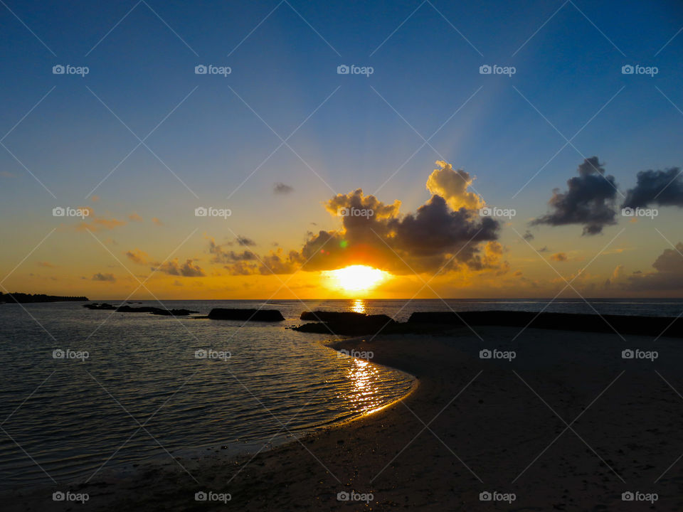 The setting sun over the Maldives