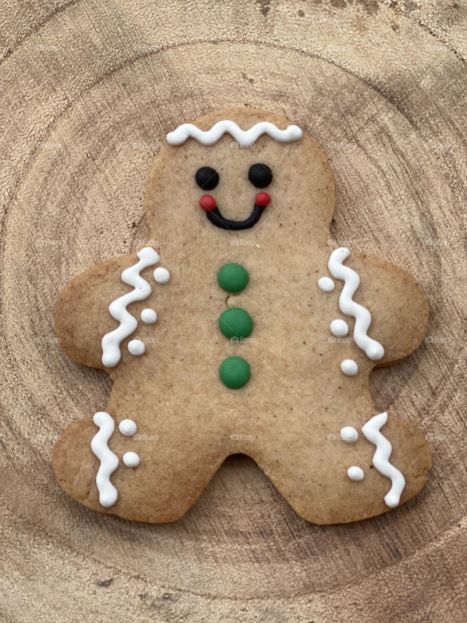 Homemade baked gingerbread on a wooden board wishing a Merry Christmas 