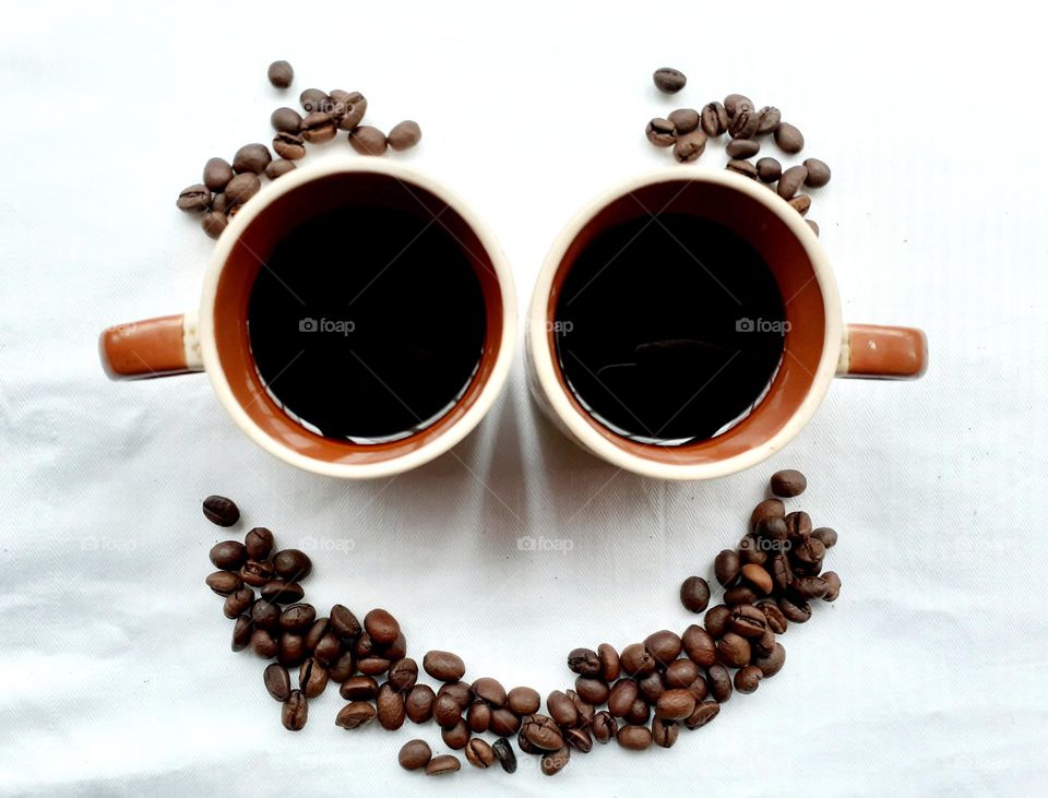 Smiling emoticon made of coffee freshly beans