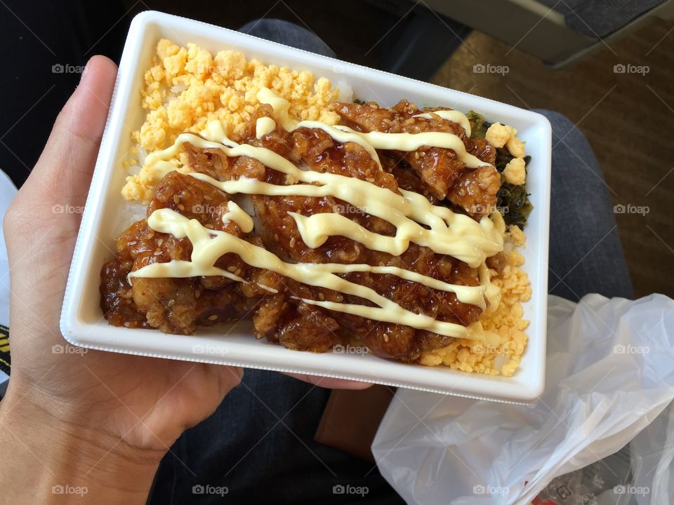 A fried chicken bento on a train in Japan