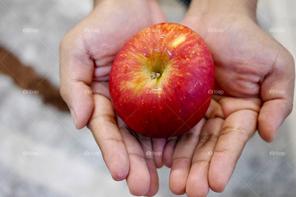 Holding red apple