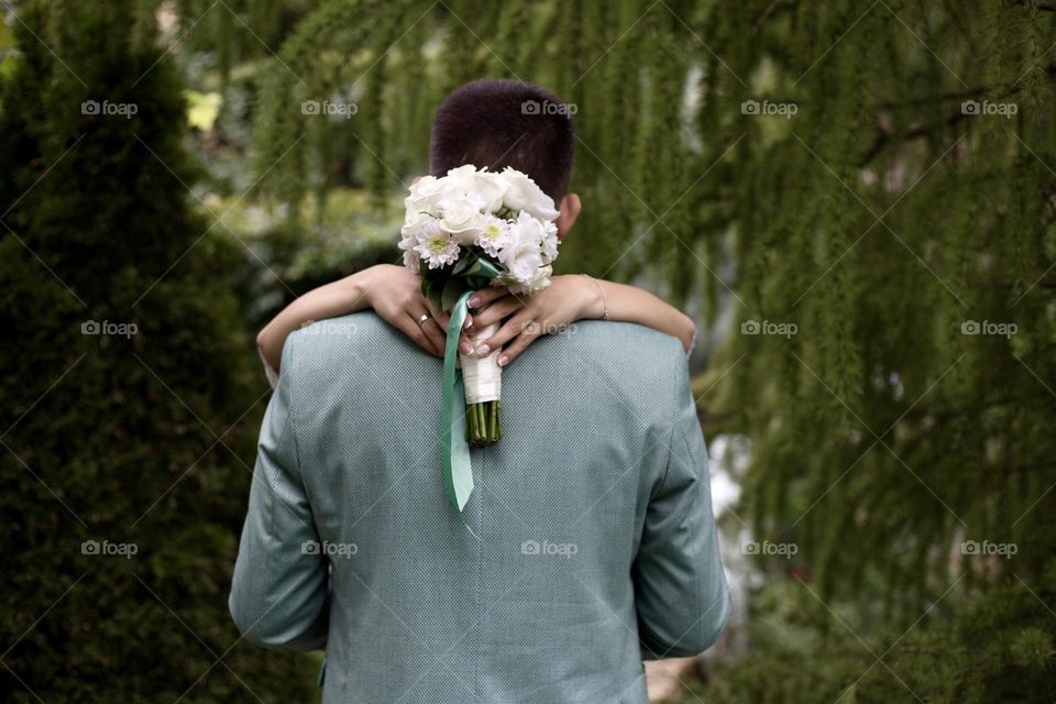 Bride and groom are hugging 