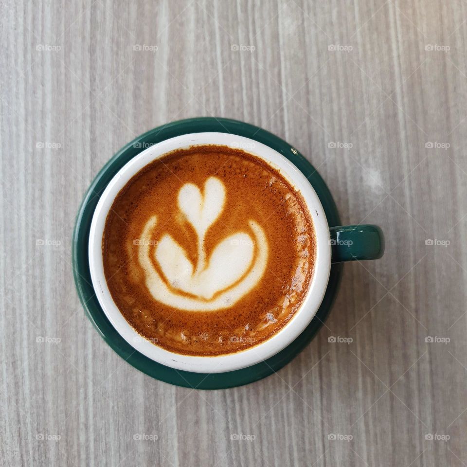 a cup of cappuccino on the table