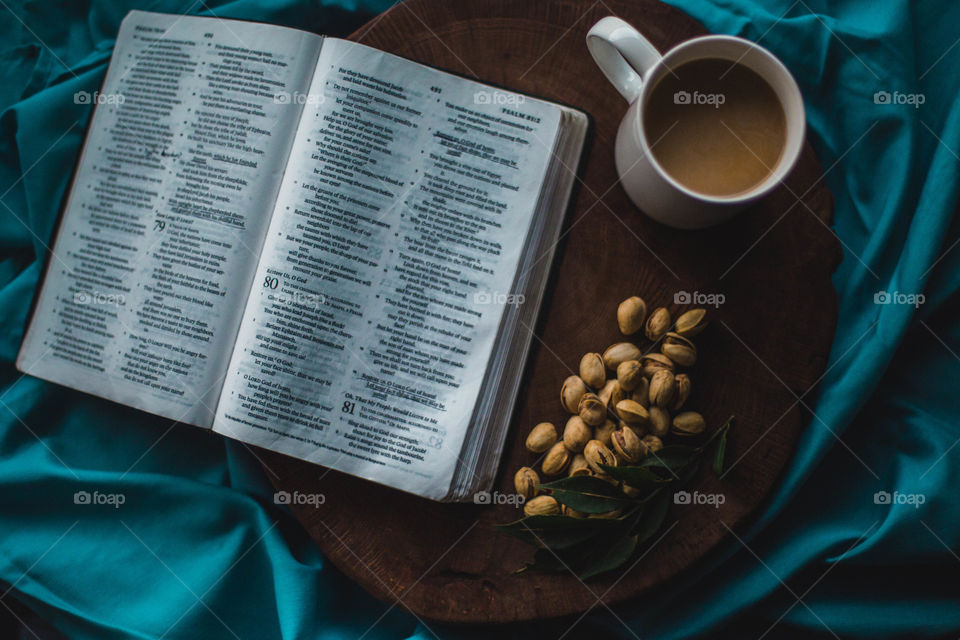 A bible, pistachios and coffee
