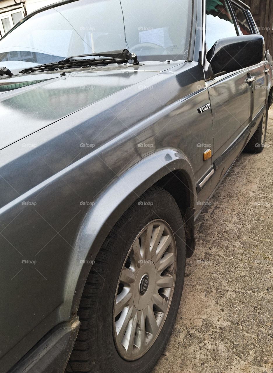 side of a gray vintage car, namely a 1986 Volvo