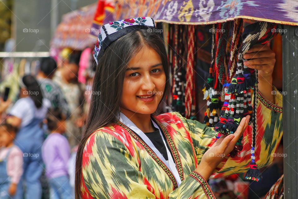 independence day in Uzbekistan. On the day of the holiday, people honor traditions by dressing up in national costumes and organizing fairs with performances.  in the photo of a girl in national festive  dresses.