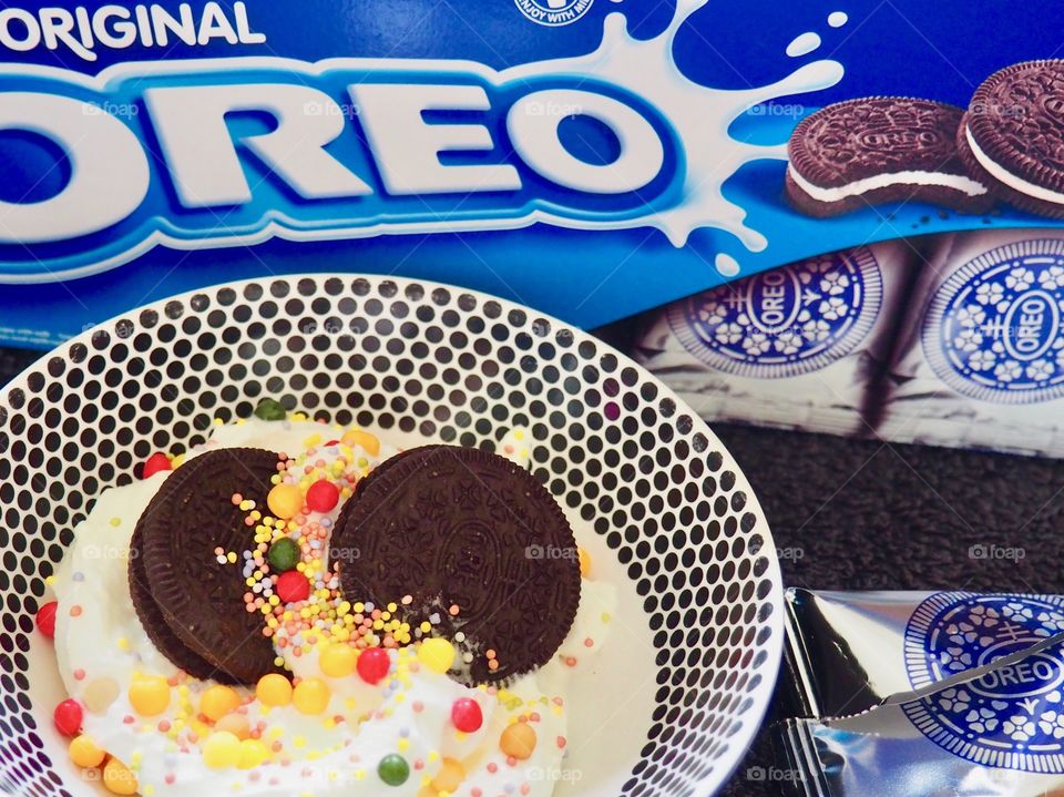 Oreo cookies with whipped cream and candy sprinkles.