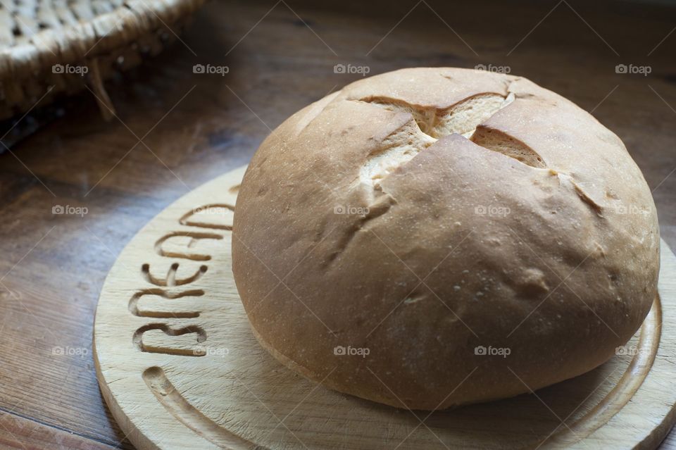 Round small bread on wooden plate
