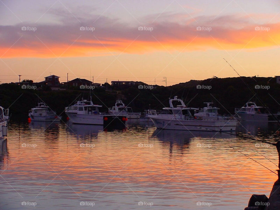 sunset orange clouds boats by kshapley