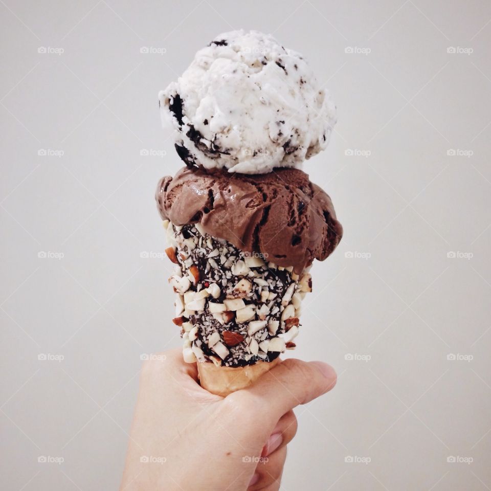 Hand holding double ice cream cone