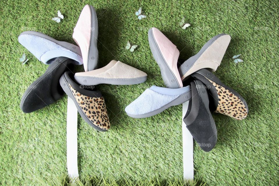 Isotoner slippers placed to make shape of pinwheels 