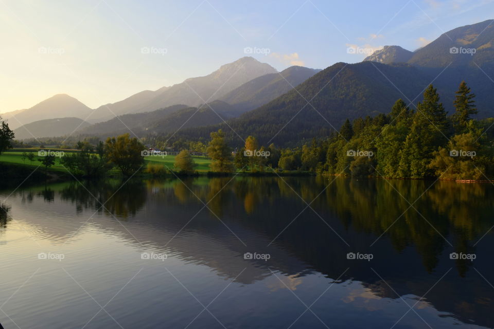 Reflection of trees and mountain on lake